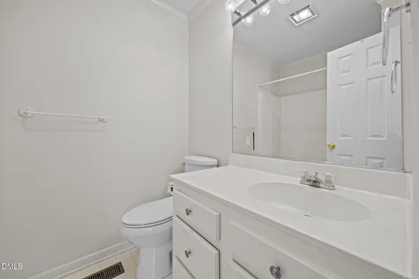 a bathroom with a sink a toilet and vanity
