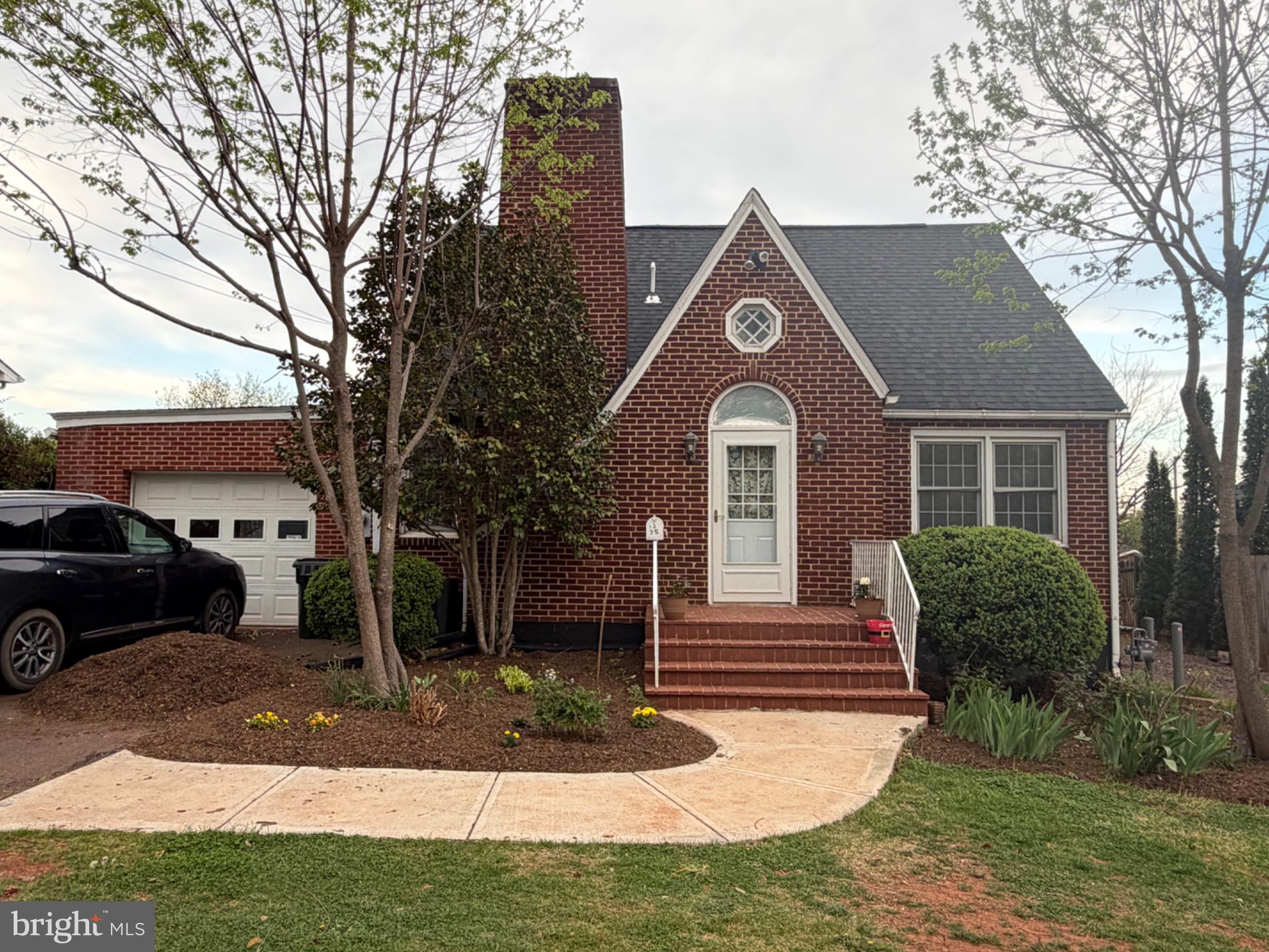 1235 South Blue Ridge Avenue Culpeper, VA 22701 - Photo 1 of 20 Charming brick home with lush greenery.
