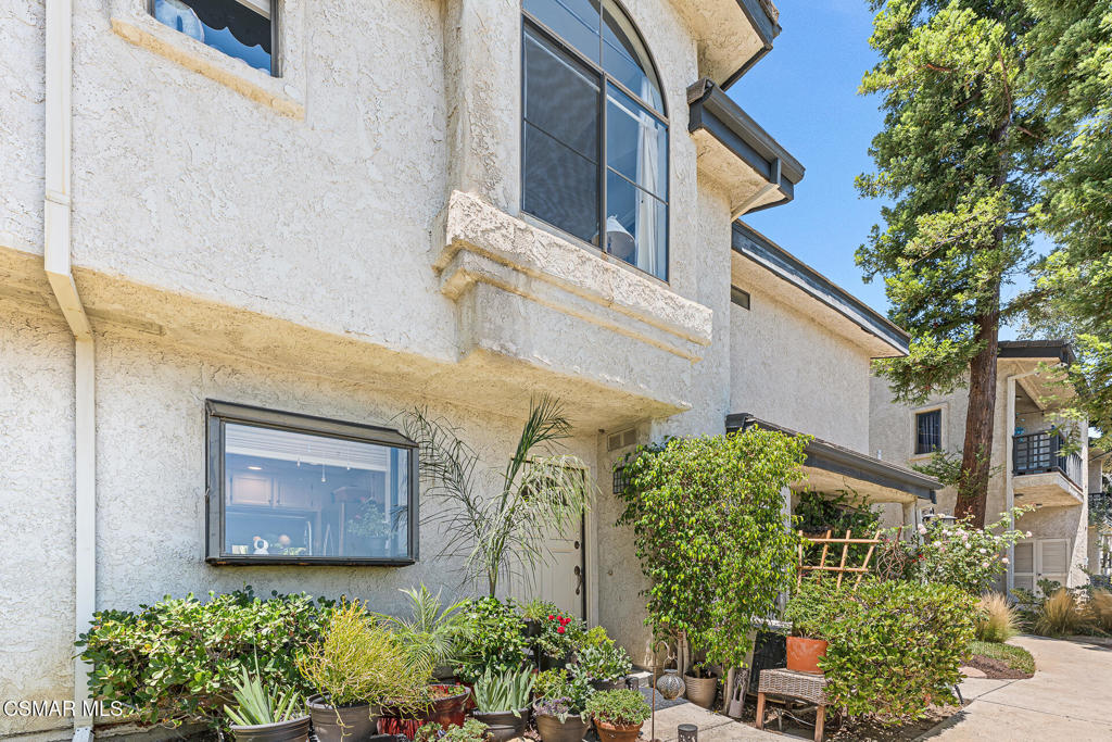 a front view of a house with plants