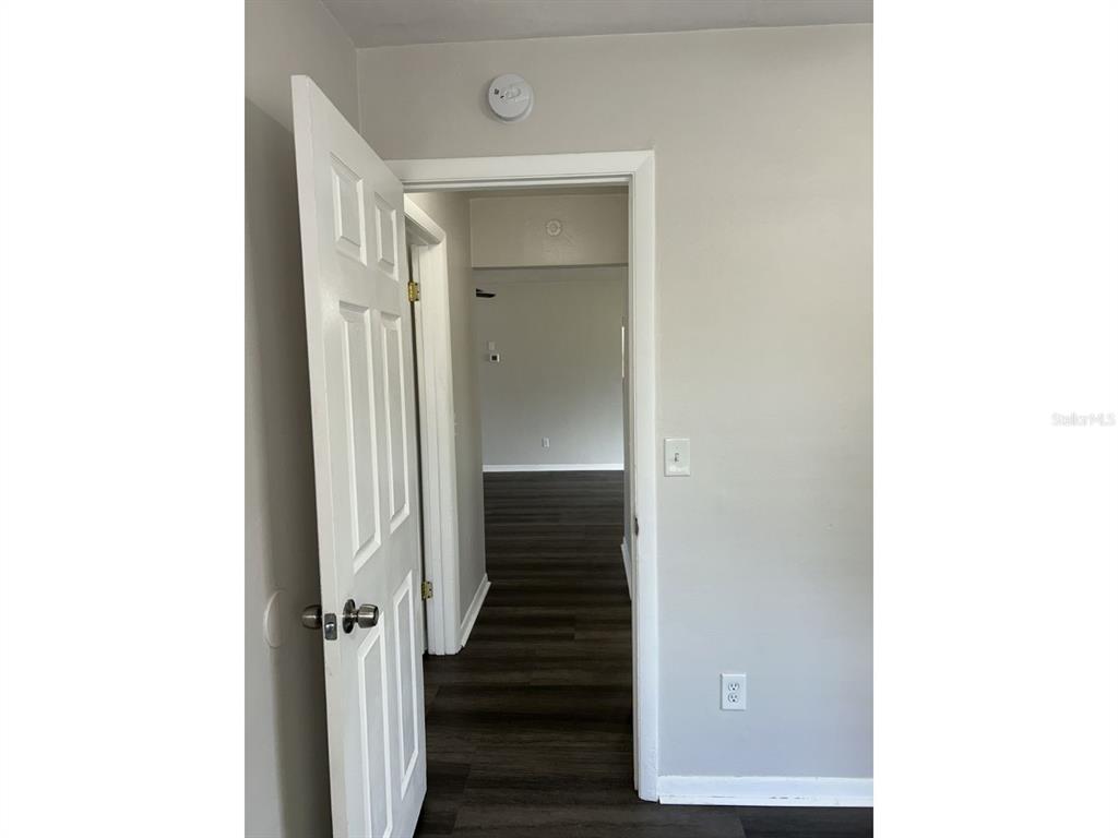 1241 Pilgrim Road Spring Hill, FL 34606 - Photo 18 of 28 a view of a hallway with wooden floor and stairs