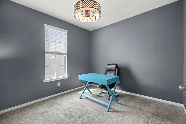a spacious bedroom with a bed and a ceiling fan