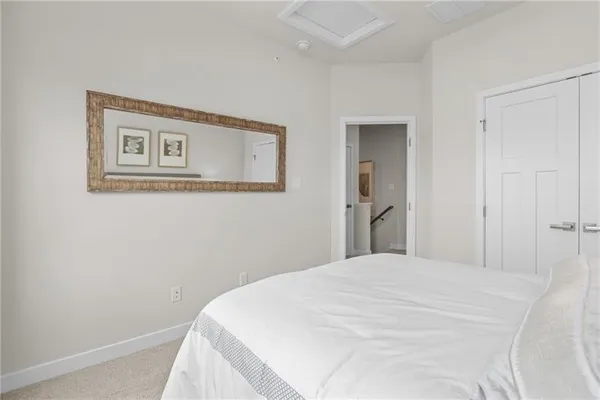 a bedroom with a bed and wall painting