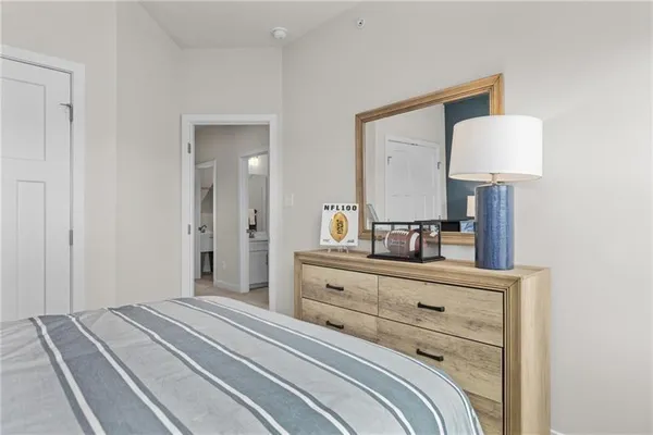 a bedroom with a bed and a mirror