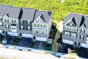 a front view of a residential apartment building with a yard