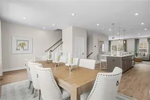 a dining room with furniture and a view of kitchen