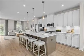 a large white kitchen with lots of counter space and windows