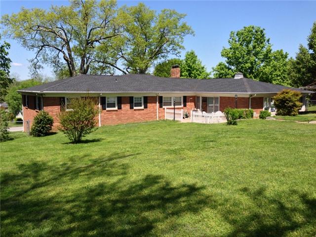 111 Tollgate Road Pulaski, TN 38478 - Photo 2 of 20 back of home, back yard is completely fenced with chain-link, features a nice patio area, and has an insulated storage building.