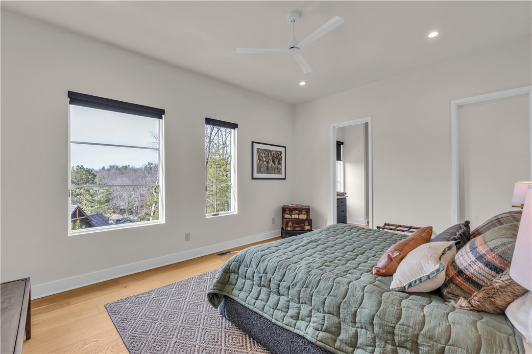 127 Crosswind Court Sunset, SC 29685 - Photo 35 of 49 This spacious bedroom offers serene views, high ceilings, and rich hardwood flooring, creating a perfect retreat.