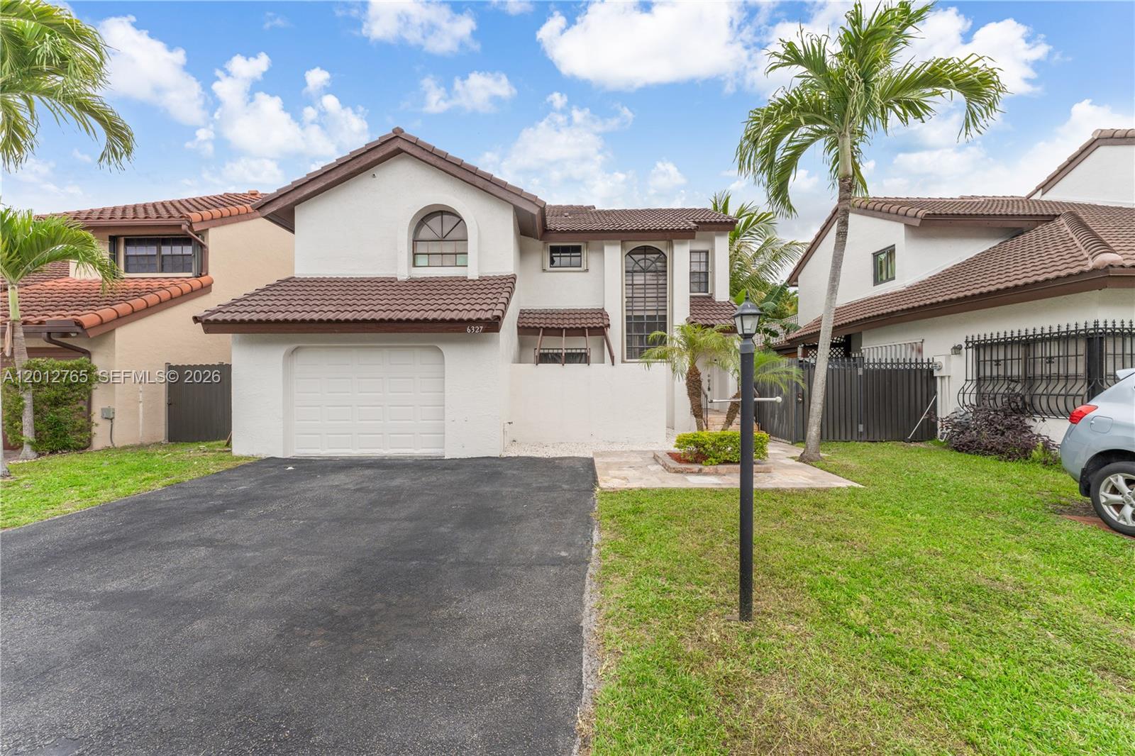 6327 Southwest 127th Place Miami, FL 33183 - Photo 1 of 48 a view of a yard in front of a house