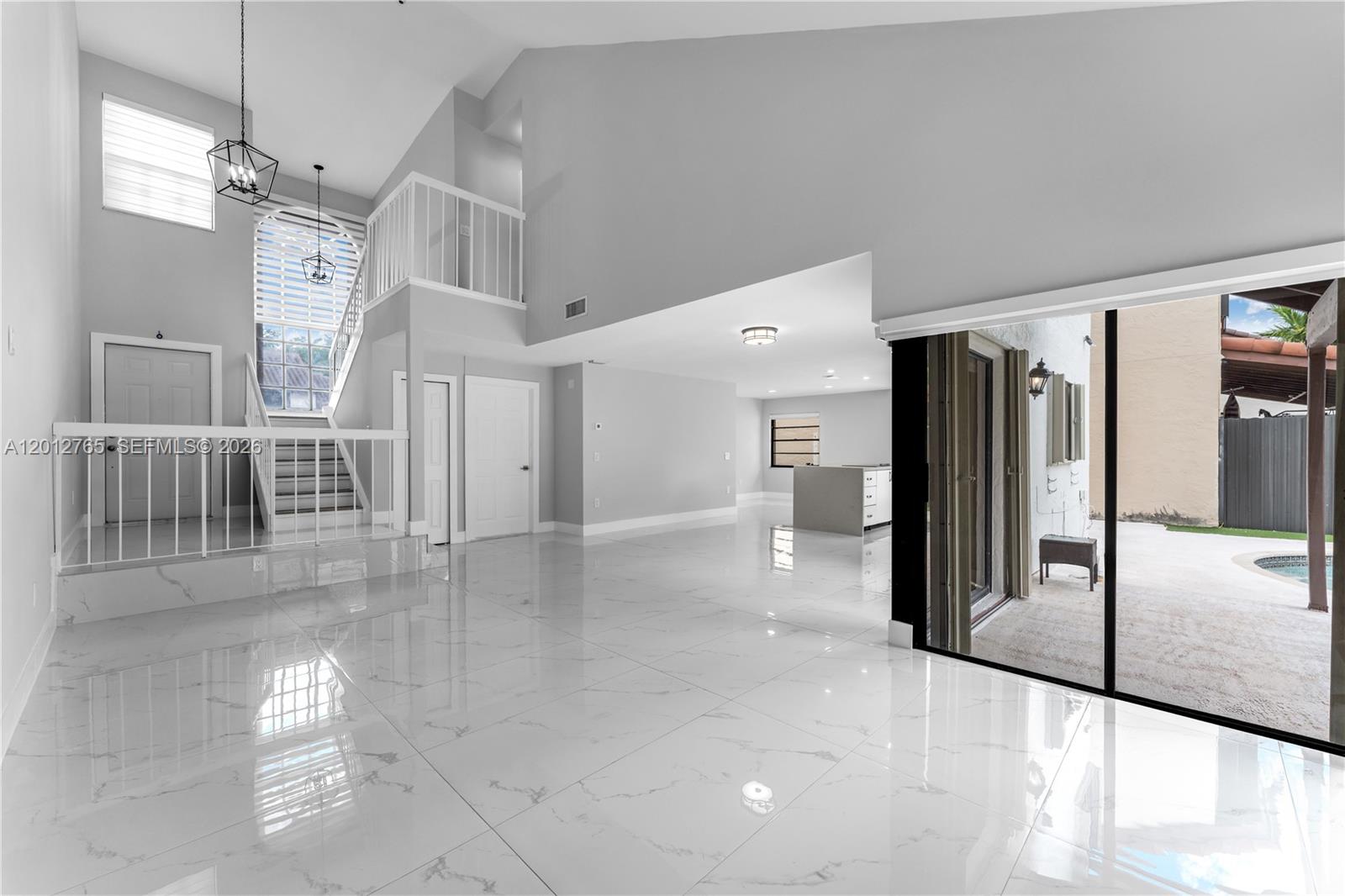6327 Southwest 127th Place Miami, FL 33183 - Photo 12 of 48 a view of a hallway with furniture and a ceiling fan