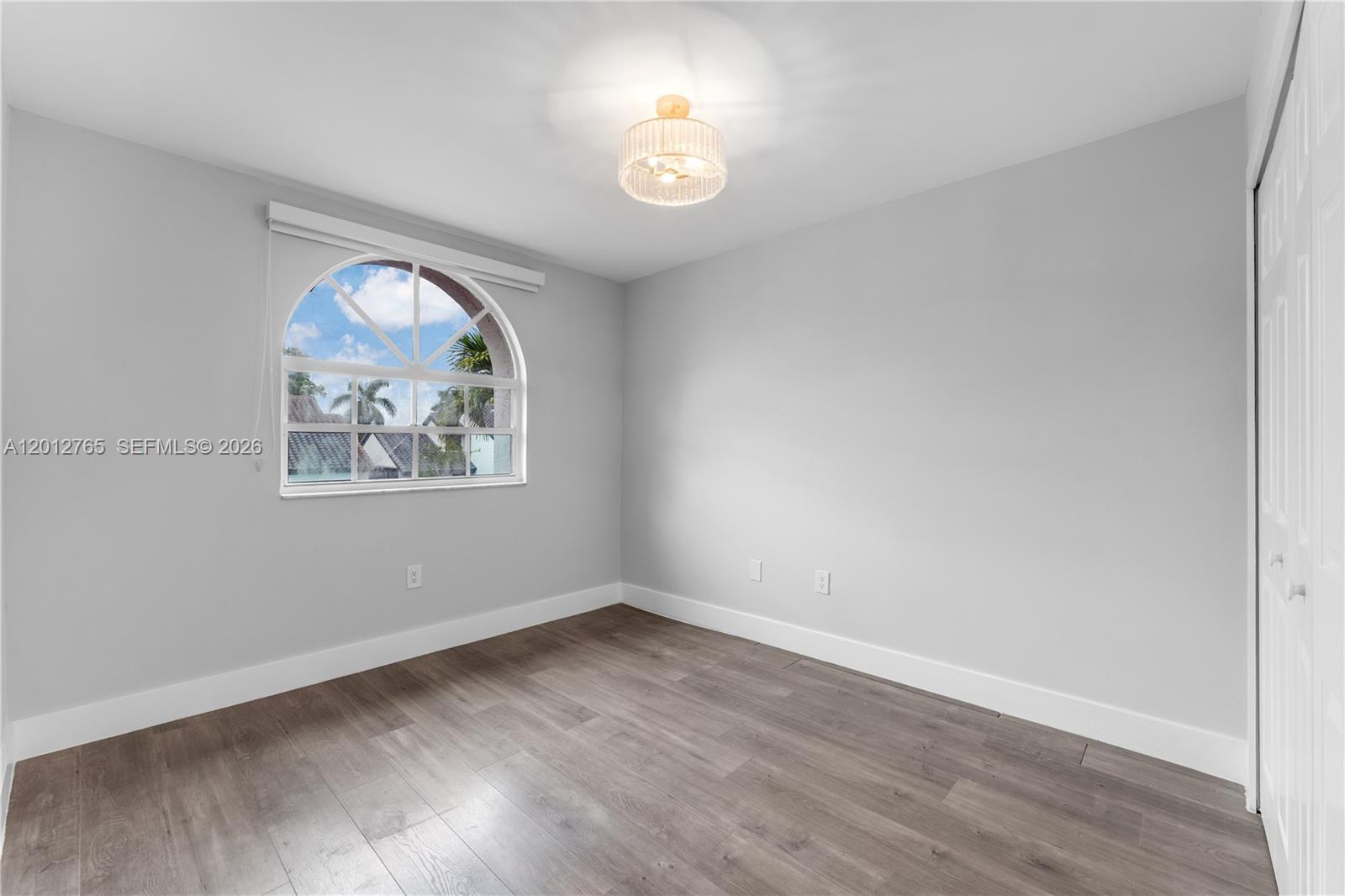 6327 Southwest 127th Place Miami, FL 33183 - Photo 16 of 48 an empty room with wooden floor and window