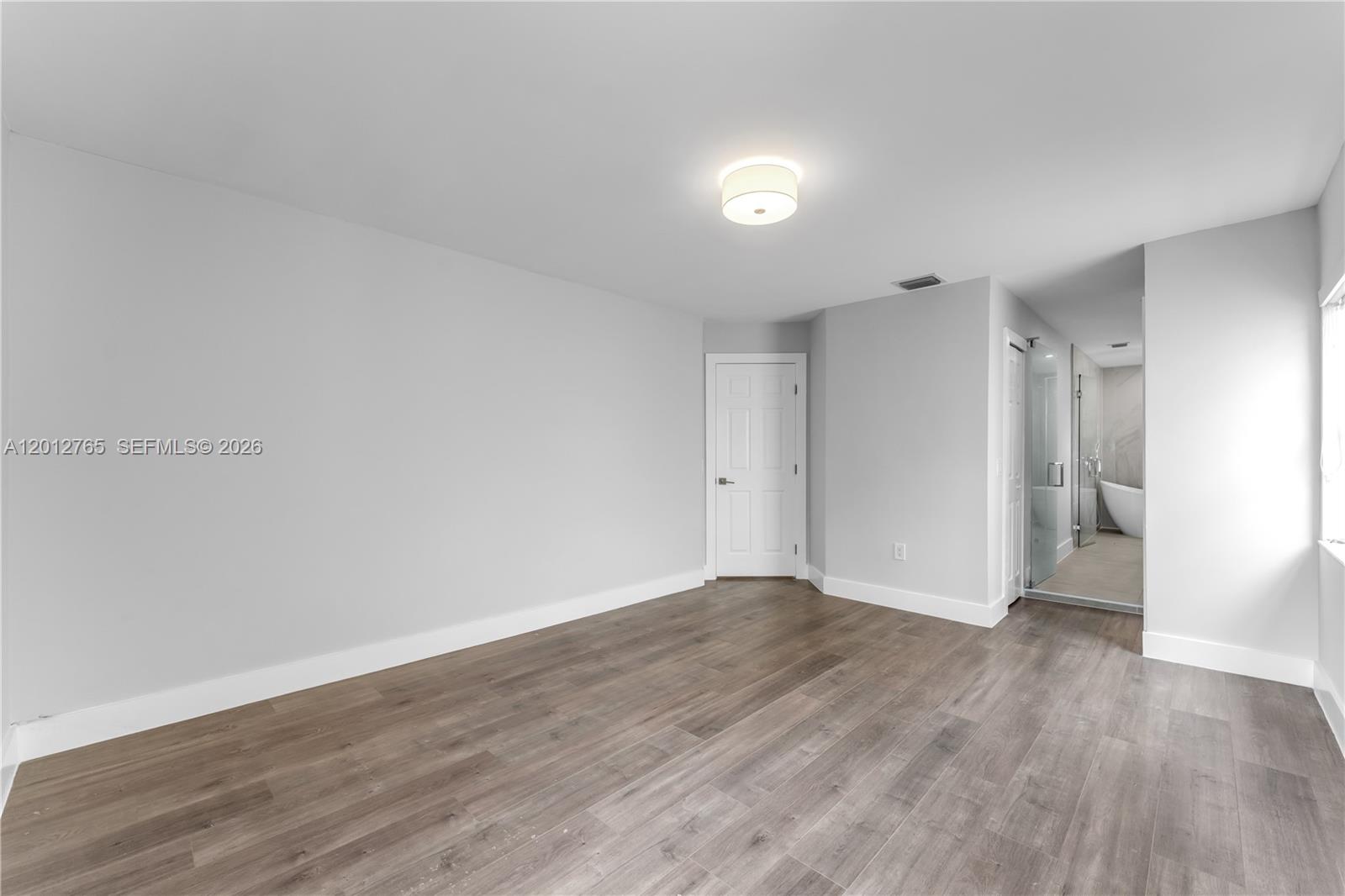 6327 Southwest 127th Place Miami, FL 33183 - Photo 20 of 48 a view of an empty room and wooden floor