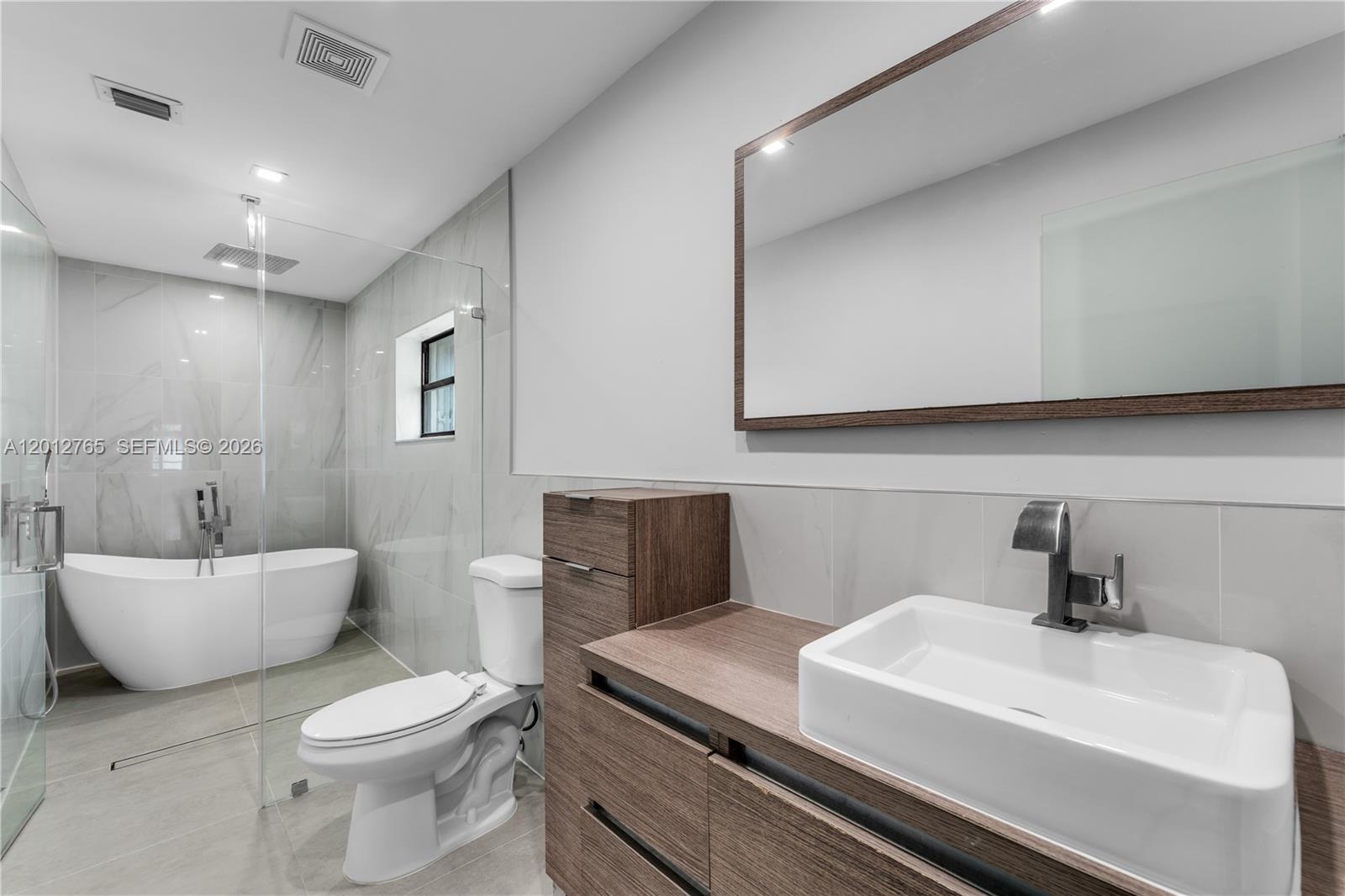 6327 Southwest 127th Place Miami, FL 33183 - Photo 21 of 48 a bathroom with a sink a toilet and mirror