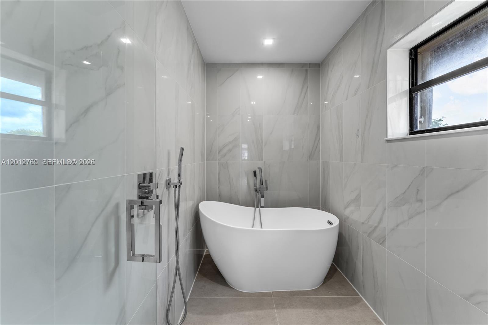 6327 Southwest 127th Place Miami, FL 33183 - Photo 22 of 48 a bathroom with a bathtub and shower