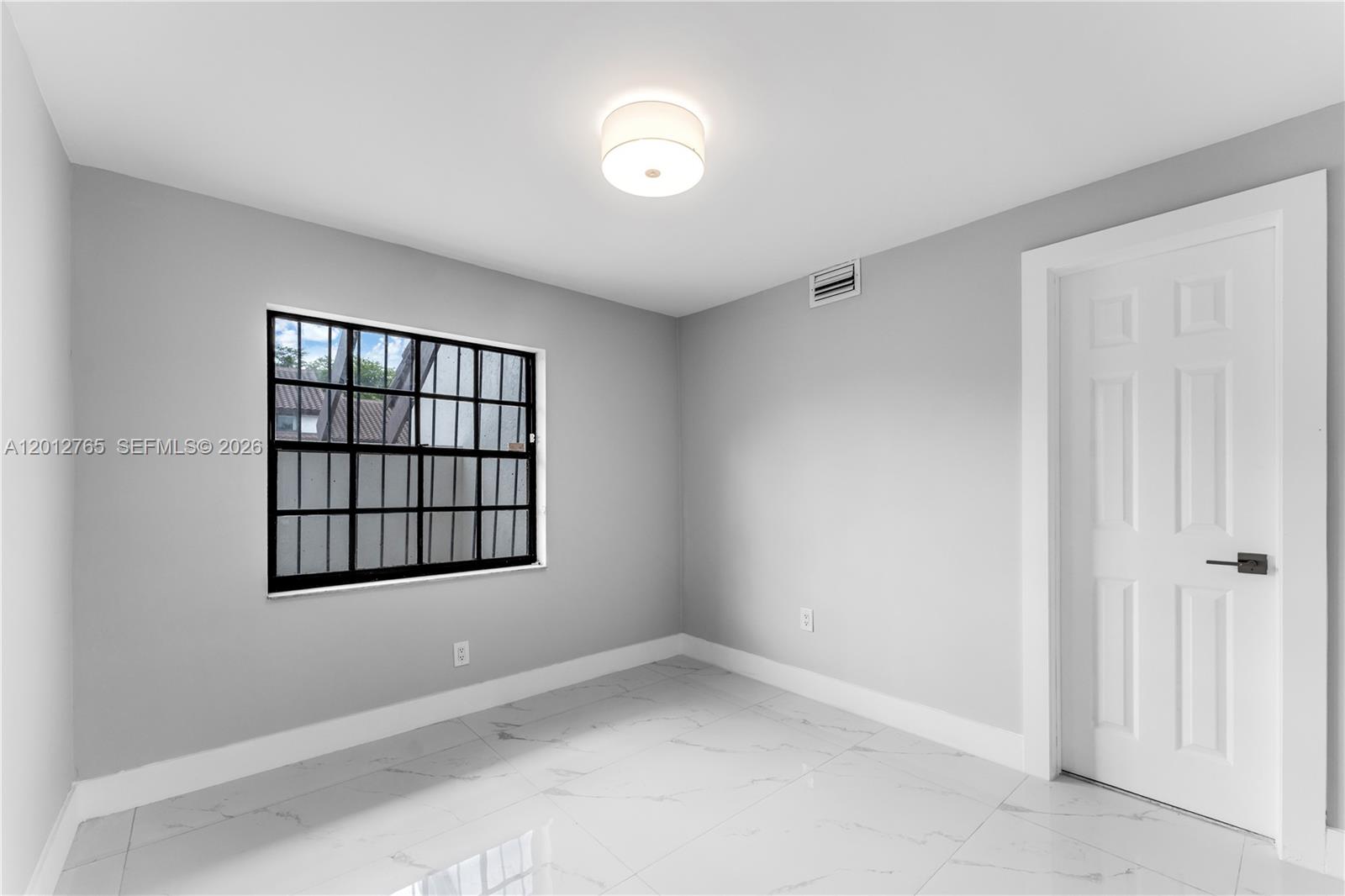 6327 Southwest 127th Place Miami, FL 33183 - Photo 26 of 48 an empty room with windows and closet