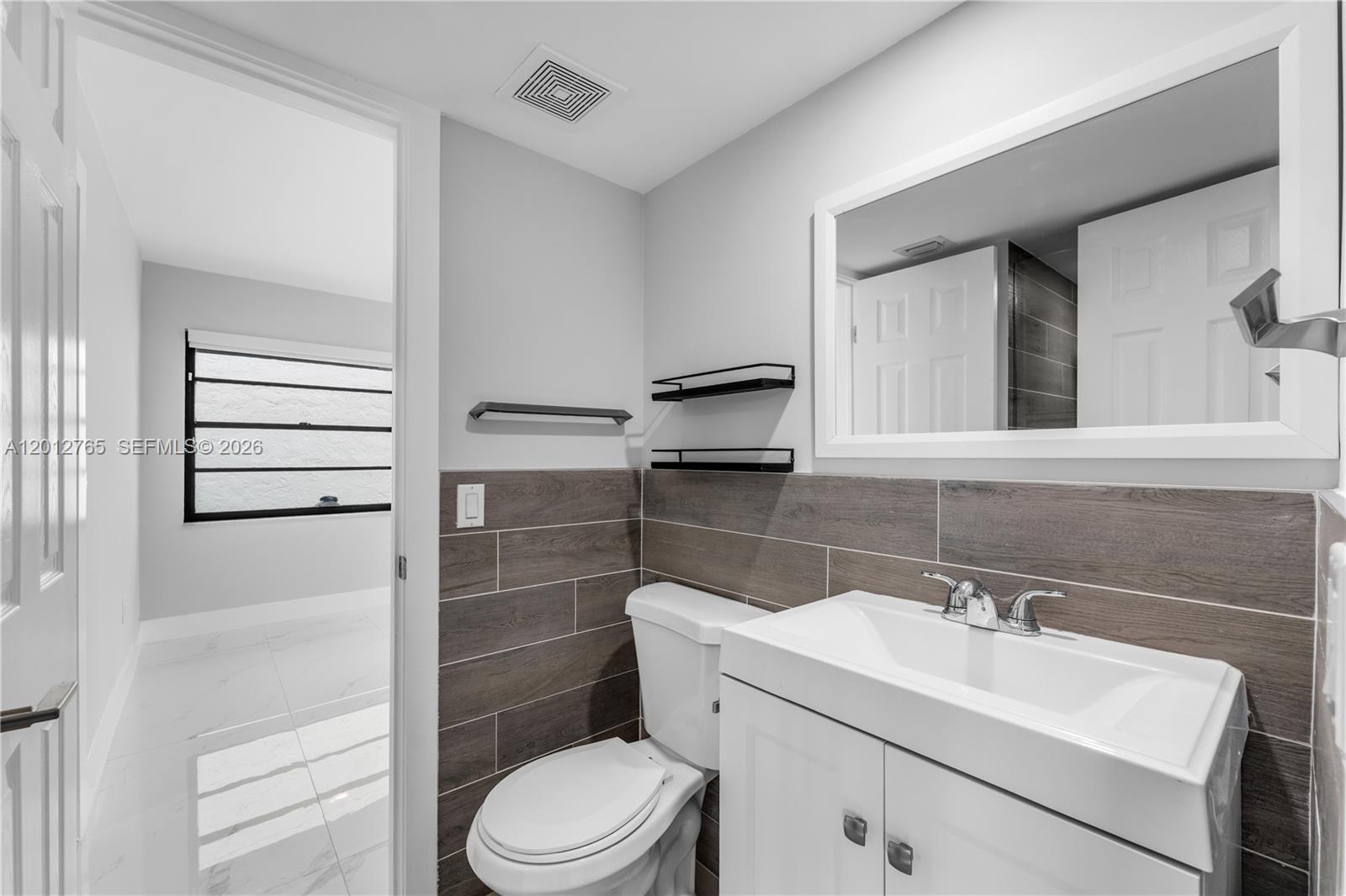6327 Southwest 127th Place Miami, FL 33183 - Photo 28 of 48 a bathroom with a sink a toilet and shower