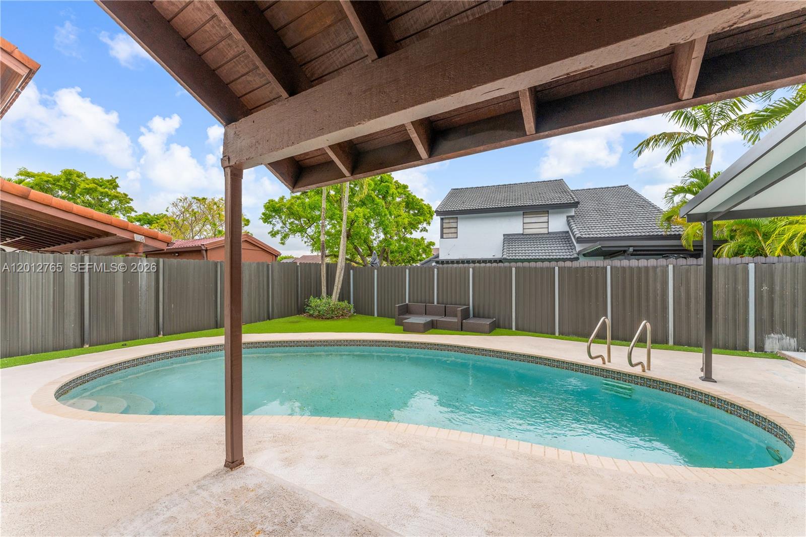 6327 Southwest 127th Place Miami, FL 33183 - Photo 31 of 48 a view of a backyard with wooden fence