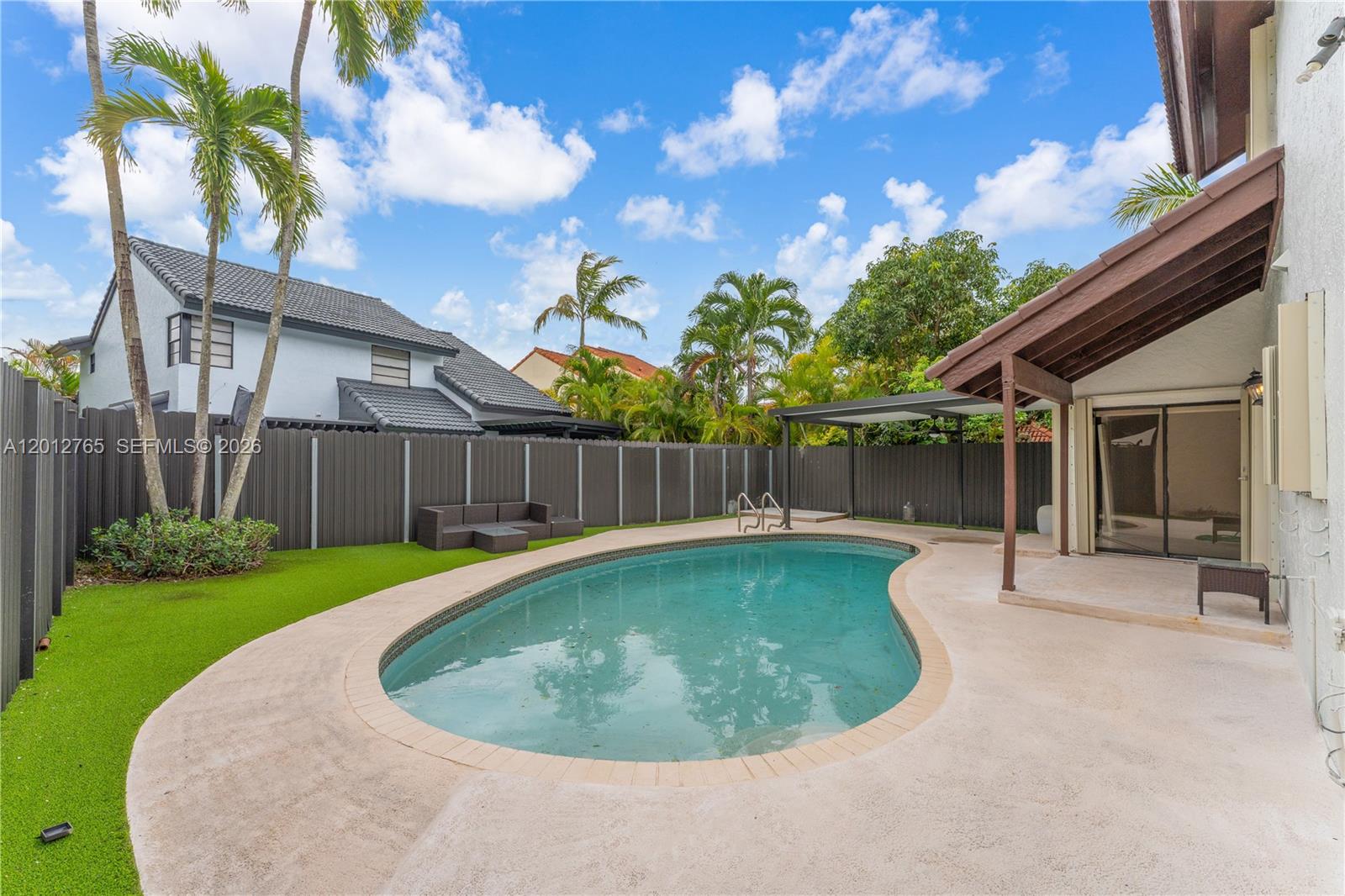 6327 Southwest 127th Place Miami, FL 33183 - Photo 32 of 48 a view of a backyard with swimming pool