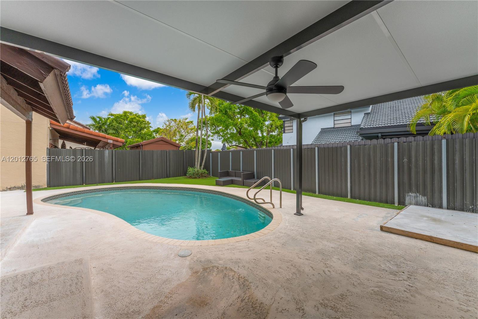 6327 Southwest 127th Place Miami, FL 33183 - Photo 35 of 48 a swimming pool with wooden fence