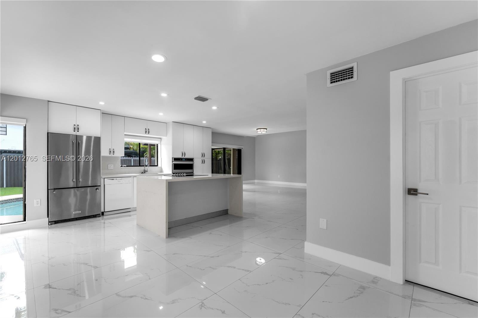 6327 Southwest 127th Place Miami, FL 33183 - Photo 7 of 48 a kitchen with stainless steel appliances a refrigerator and a stove top oven