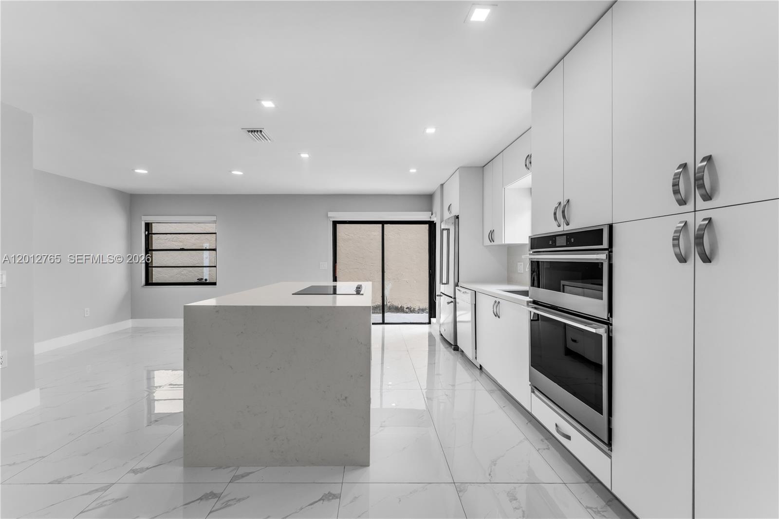 6327 Southwest 127th Place Miami, FL 33183 - Photo 10 of 48 a kitchen with stainless steel appliances a refrigerator and a stove top oven