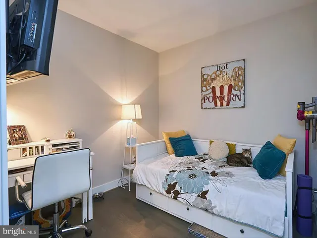 a bedroom with a bed and a desk