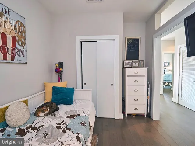 a bedroom with a bed and wooden floor