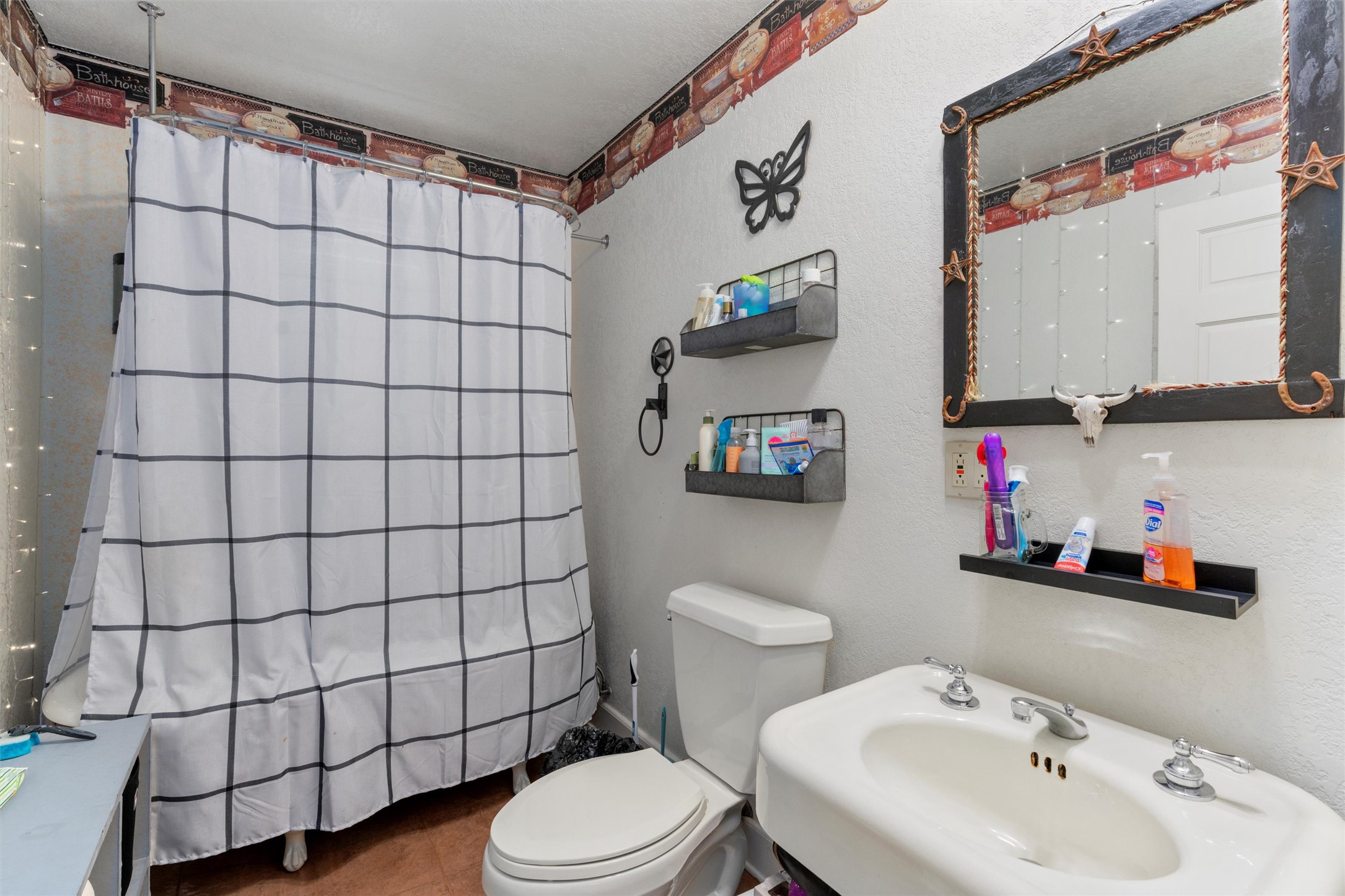 1000 County Road 215 Florence, TX 76527 - Photo 24 of 40 a bathroom with a sink toilet and shower