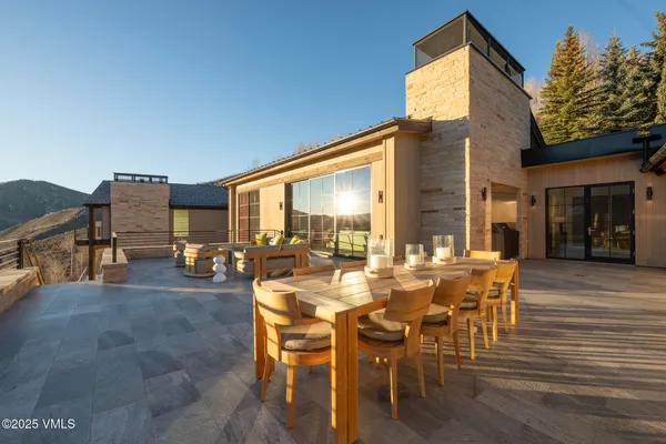 a view of a patio with table and chairs and potted plants