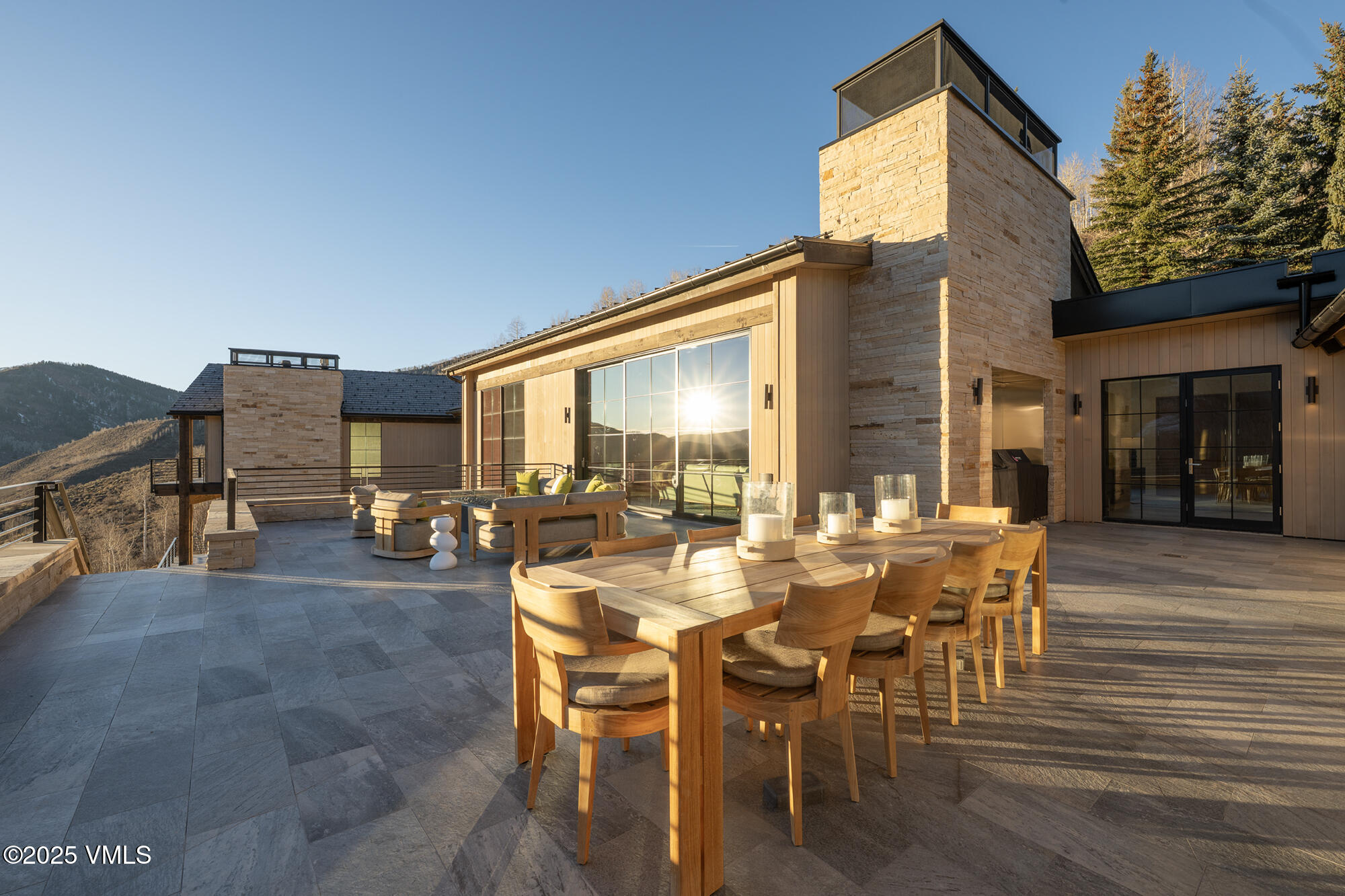 1326 Spraddle Creek Road Vail, CO 81657 - Photo 13 of 26 a view of a patio with table and chairs and potted plants