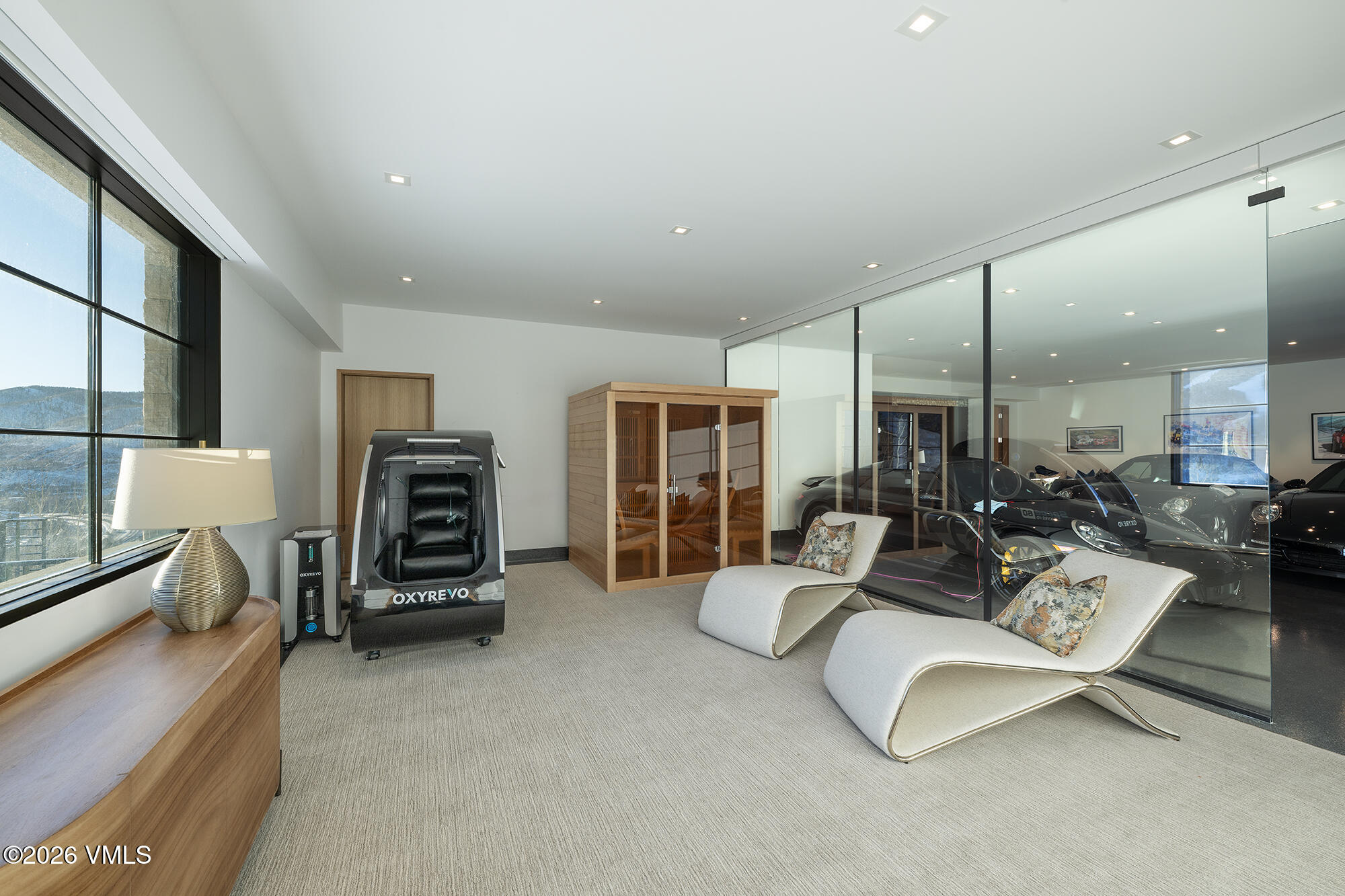 1326 Spraddle Creek Road Vail, CO 81657 - Photo 21 of 26 a living room with furniture a fireplace and gym equipment