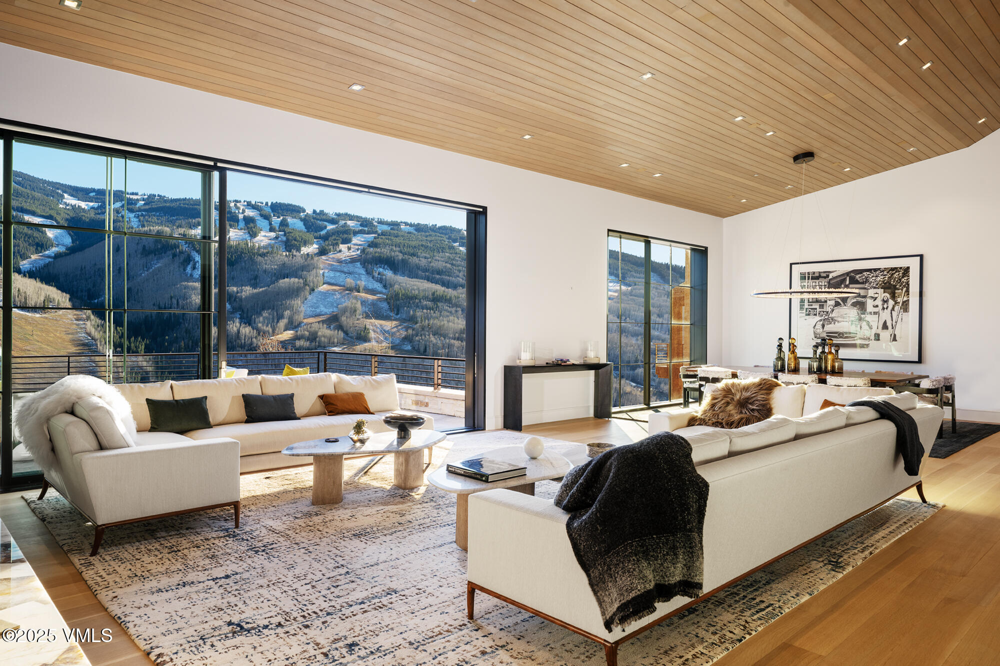 1326 Spraddle Creek Road Vail, CO 81657 - Photo 3 of 26 a living room with furniture large windows and a rug