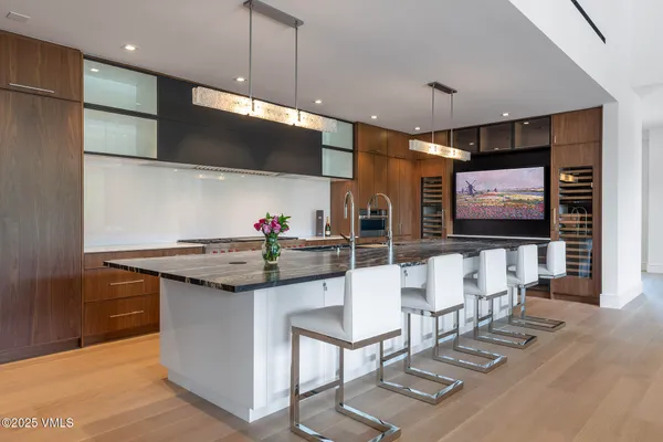 a kitchen with stainless steel appliances kitchen island granite countertop a stove a sink and a microwave