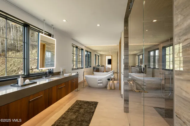 a large bathroom with a large tub and sink