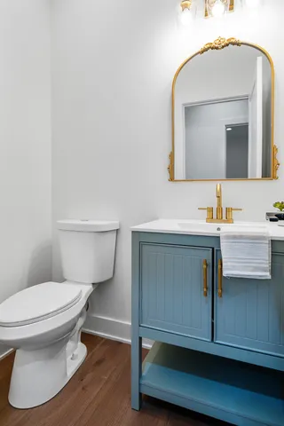 a bathroom with a toilet sink and mirror