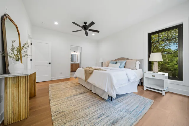a bedroom with a bed and a large window