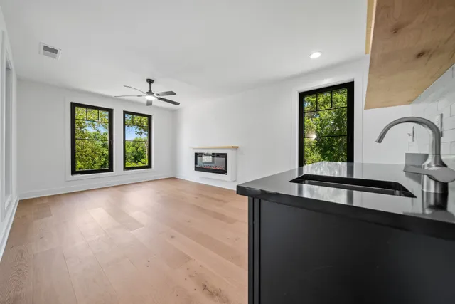 a view of a kitchen with a sink and a window
