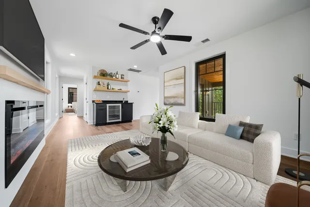 a living room with furniture fireplace and a large window