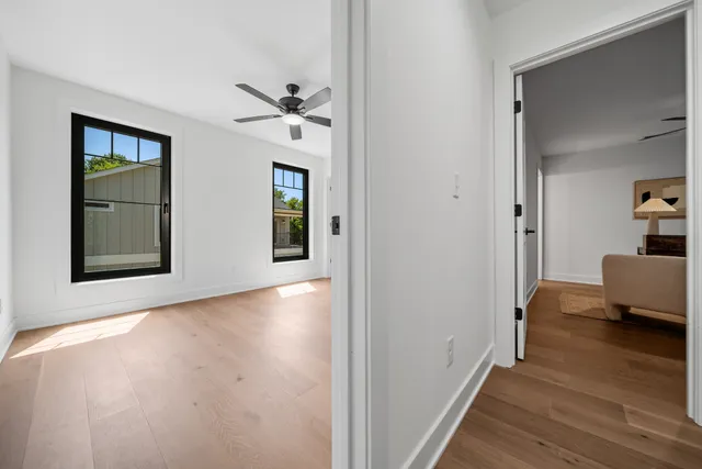 a view of a hallway with wooden floor and closet