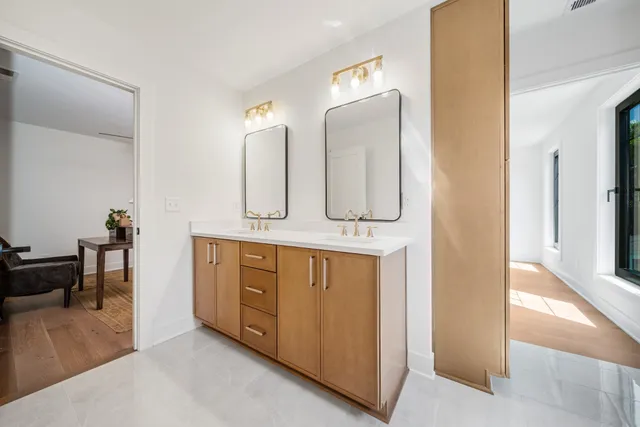 a spacious bathroom with a double vanity sink and a mirror