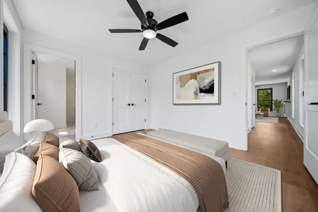 a bedroom with a large bed and a chandelier