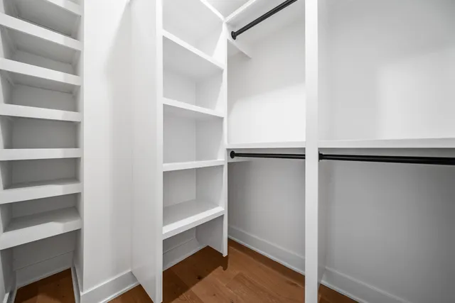 a view of walk in closet with empty racks
