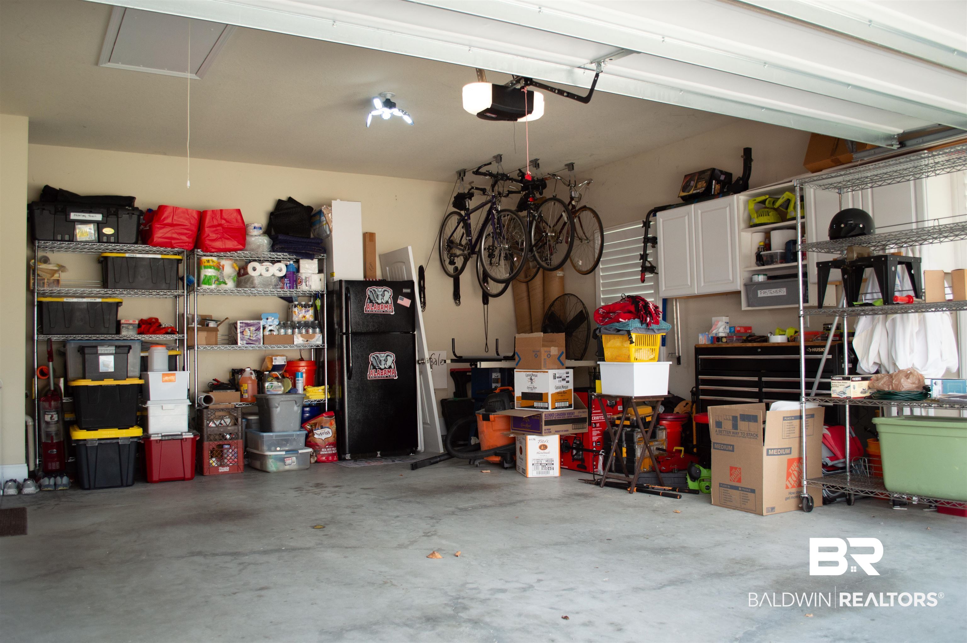 1124 West Orlando Drive Foley, AL 36535 - Photo 42 of 51 Garage with freestanding refrigerator and a garage door opener