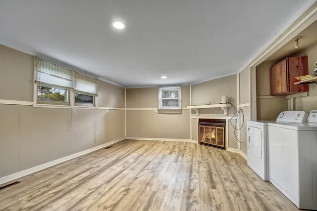 a view of empty room with a fireplace and cabinet