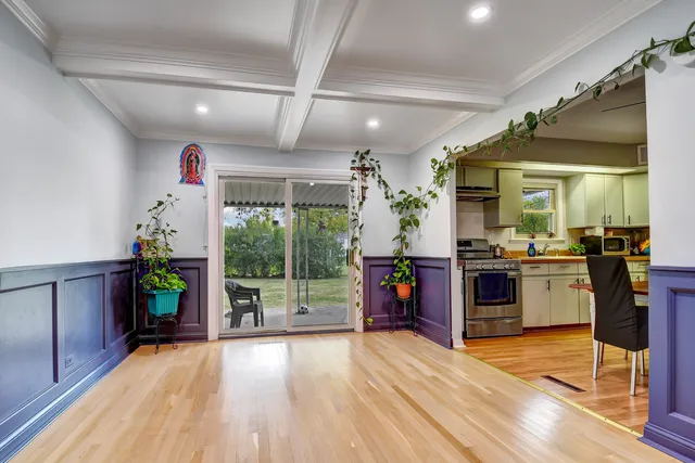 a open kitchen with stainless steel appliances granite countertop a refrigerator and a wooden floors