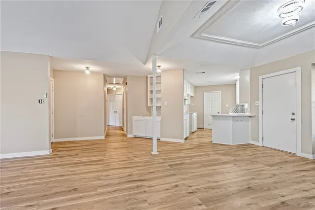 a view of a kitchen entryway with wooden floor