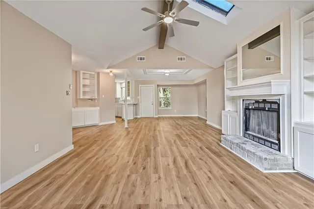 wooden floor in an empty room with a fireplace