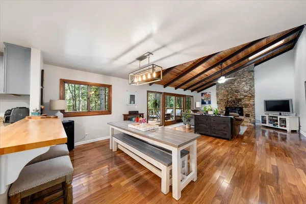 a living room with furniture a flat screen tv and a large window