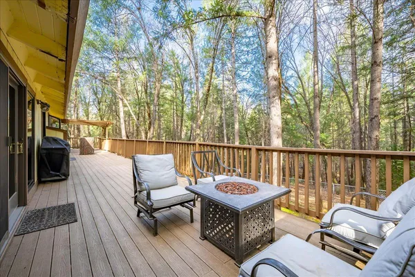 a balcony with furniture and wooden floor