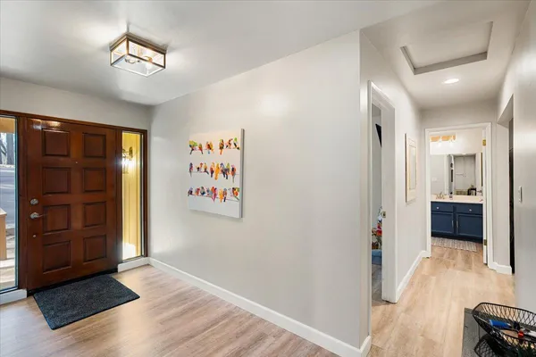 a view of a hallway with wooden floor and closet